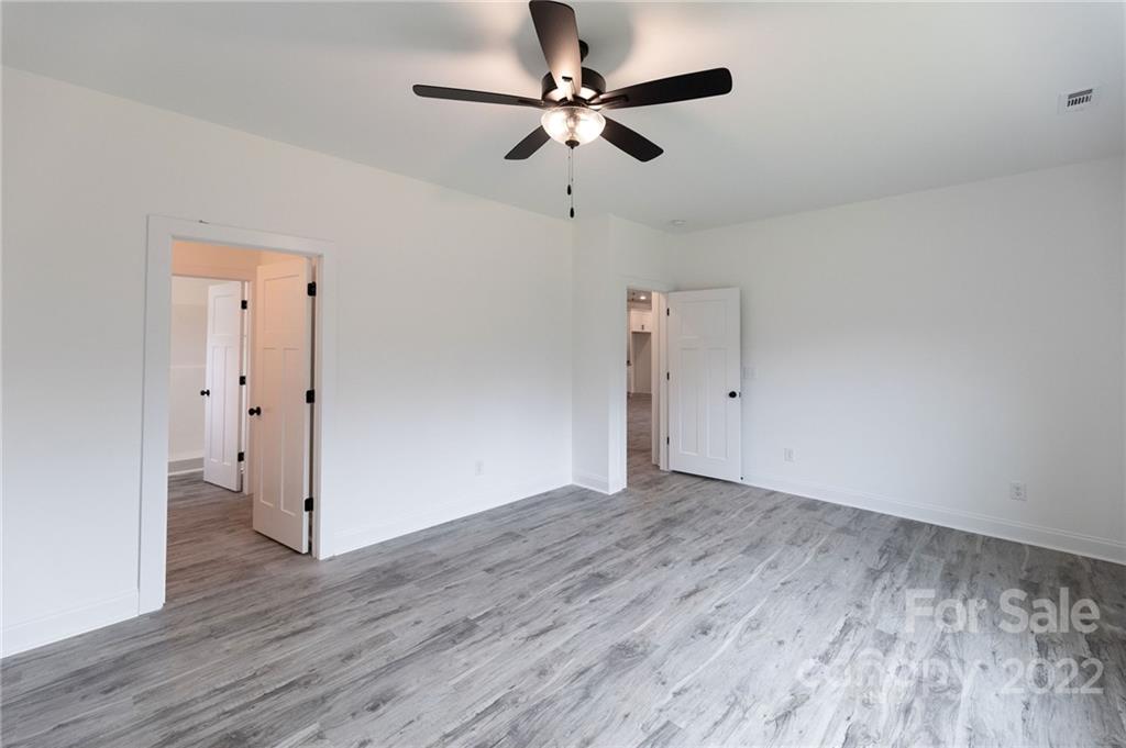 2231 State Rd S-46-1474, Unit 17 Clover, SC 29710 - Photo 10 of 20 an empty room with wooden floor ceiling fan and window