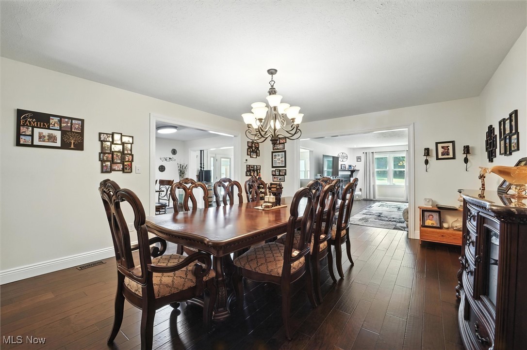 2930 South Ridge Road East Kingsville, OH 44048 - Photo 16 of 49 Dining room featuring a chandelier and dark wood finished floors