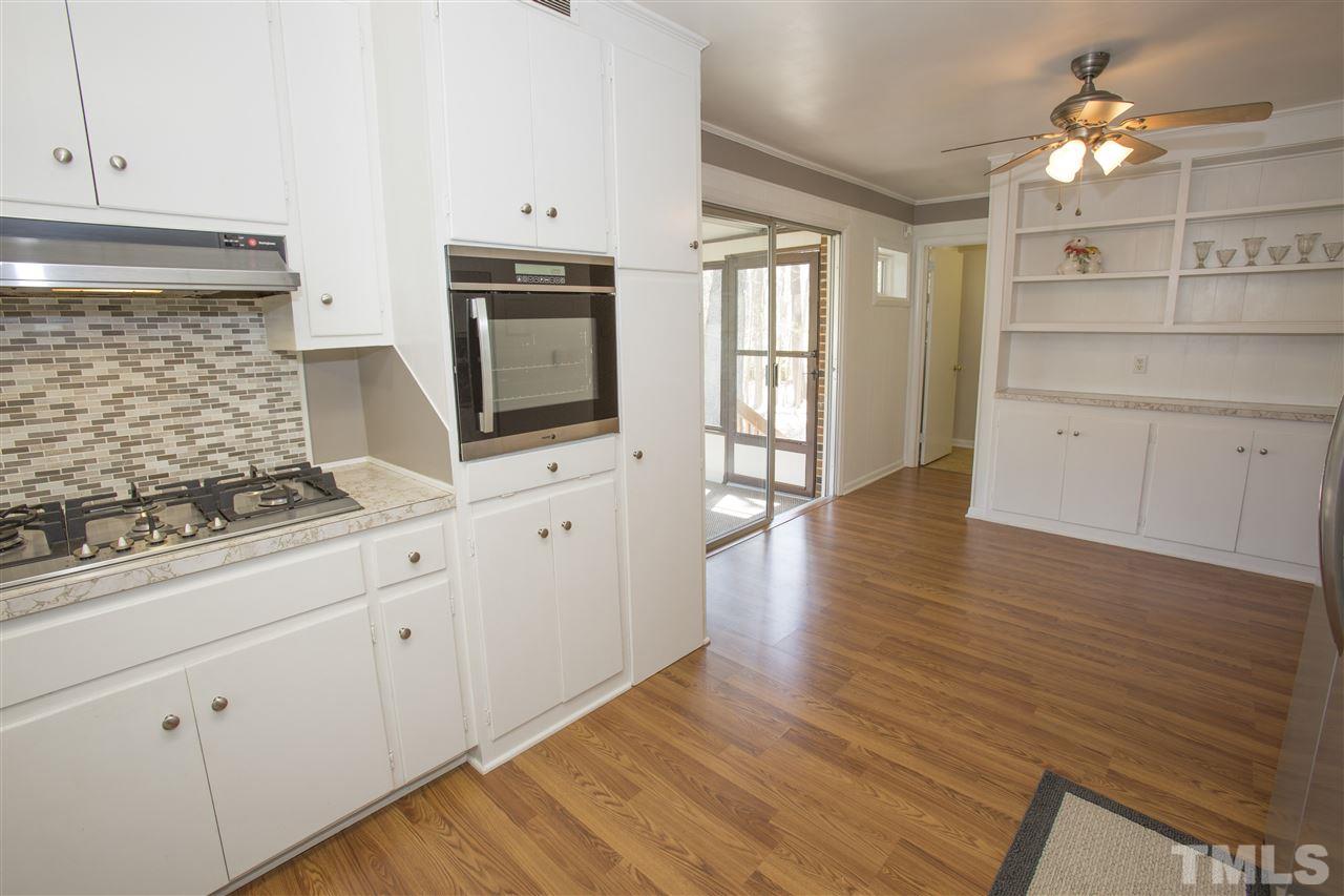 11100 Creedmoor Road Raleigh, NC 27614 - Photo 11 of 25 a kitchen with granite countertop white cabinets and stainless steel appliances