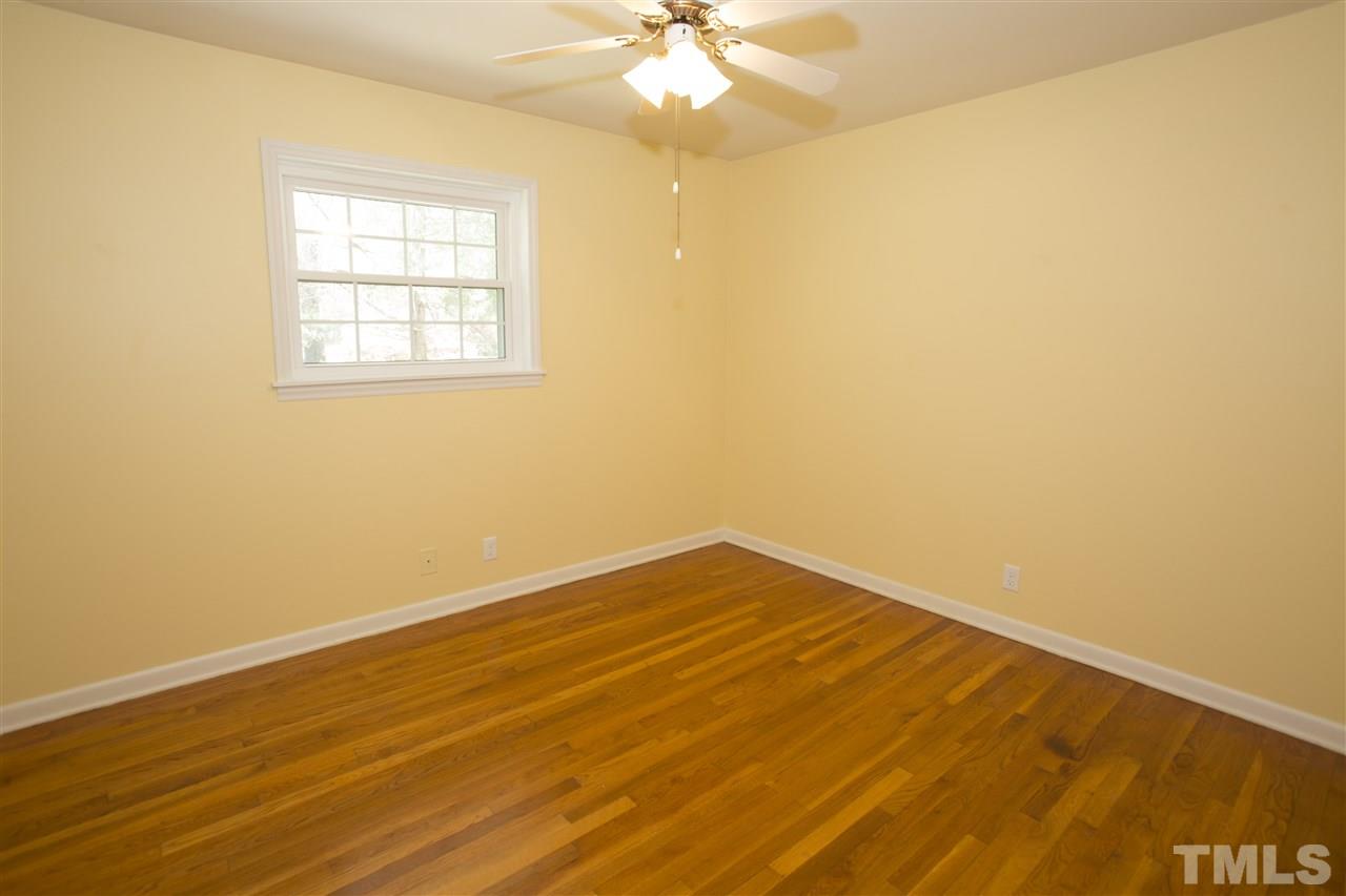 11100 Creedmoor Road Raleigh, NC 27614 - Photo 14 of 25 an empty room with wooden floor and fan