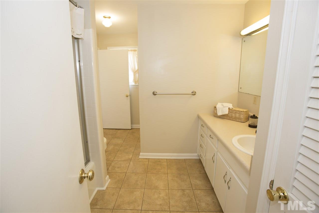 11100 Creedmoor Road Raleigh, NC 27614 - Photo 16 of 25 a bathroom with a granite countertop sink a toilet and shower