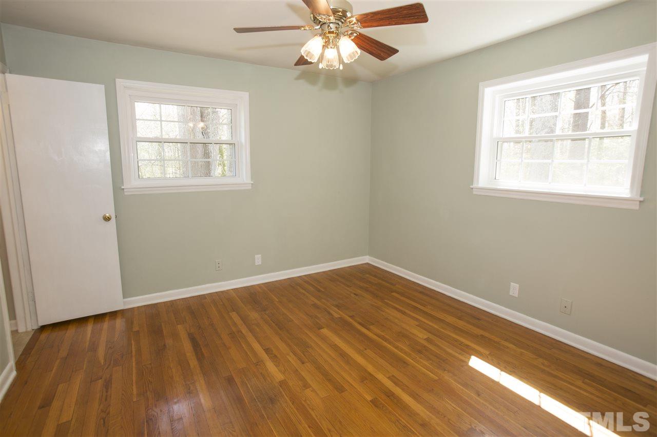 11100 Creedmoor Road Raleigh, NC 27614 - Photo 18 of 25 a view of an empty room with wooden floor and a window