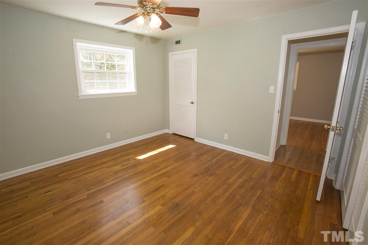 11100 Creedmoor Road Raleigh, NC 27614 - Photo 19 of 25 an empty room with wooden floor and a ceiling fan