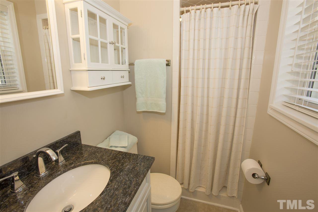 11100 Creedmoor Road Raleigh, NC 27614 - Photo 20 of 25 a bathroom with a granite countertop sink and a mirror