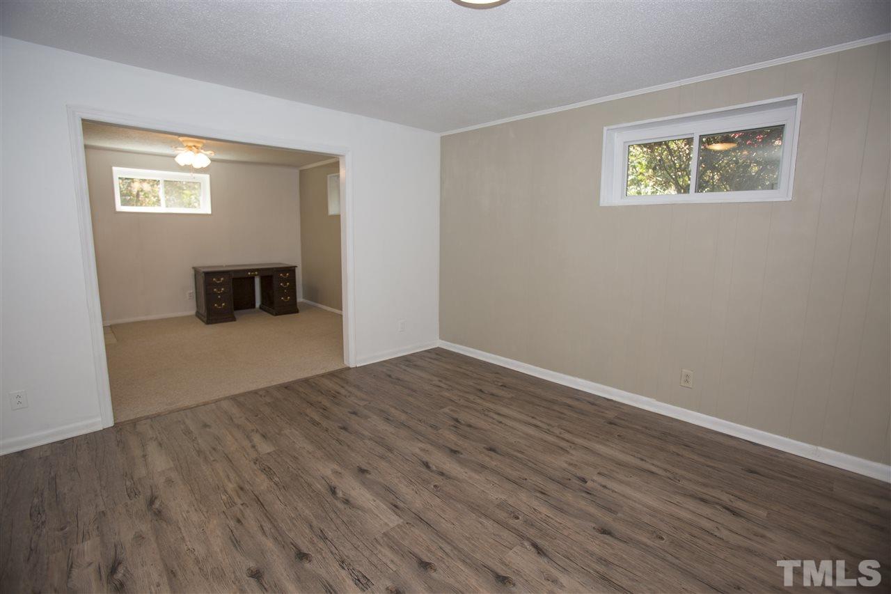 11100 Creedmoor Road Raleigh, NC 27614 - Photo 21 of 25 a view of empty room with wooden floor and fan