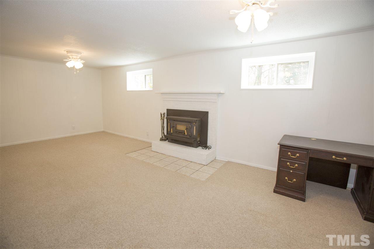 11100 Creedmoor Road Raleigh, NC 27614 - Photo 22 of 25 an empty room with a fireplace