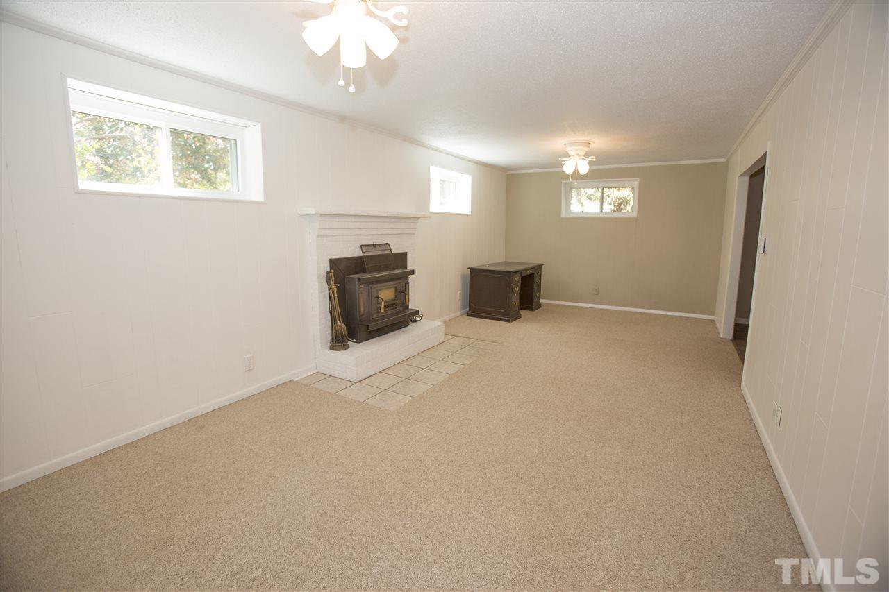 11100 Creedmoor Road Raleigh, NC 27614 - Photo 23 of 25 en empty room with windows and fireplace