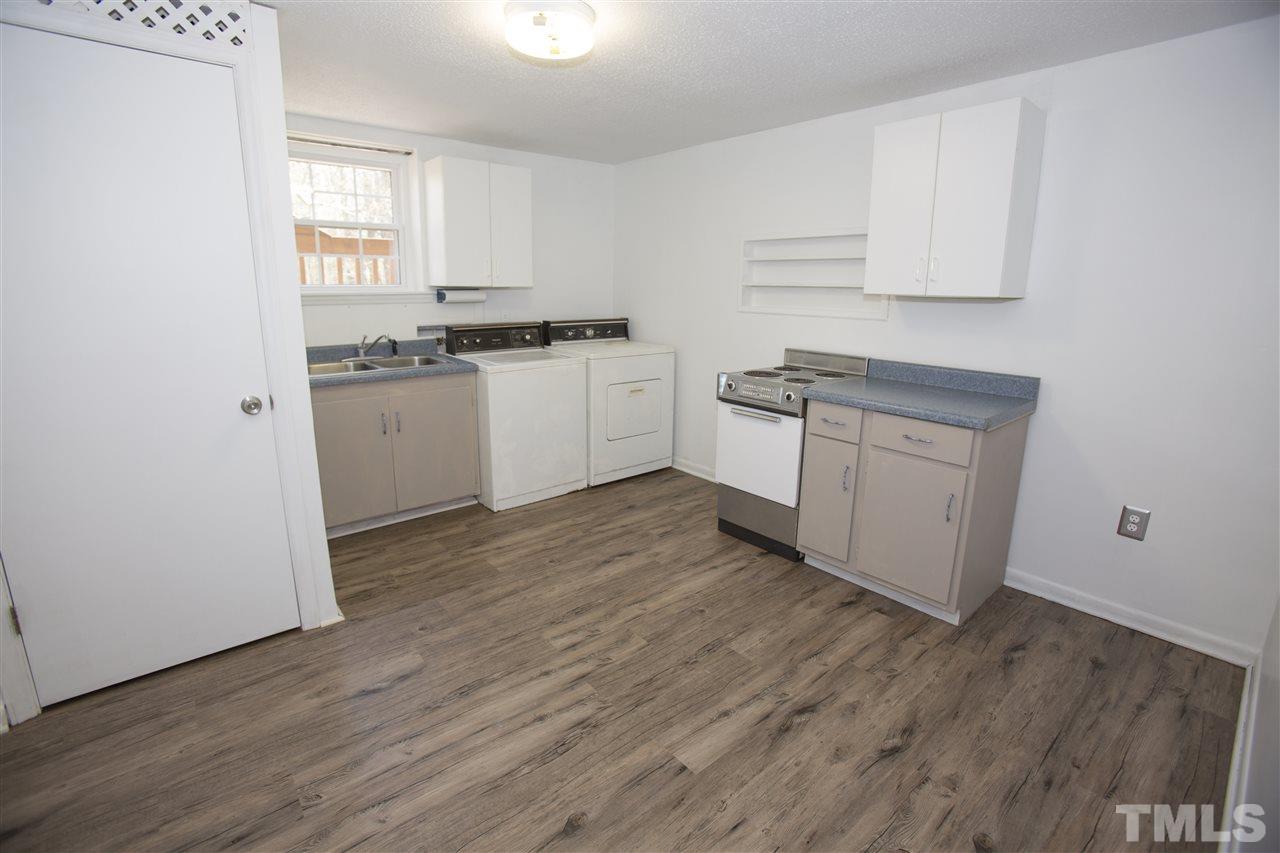 11100 Creedmoor Road Raleigh, NC 27614 - Photo 24 of 25 a kitchen with granite countertop white cabinets and white appliances