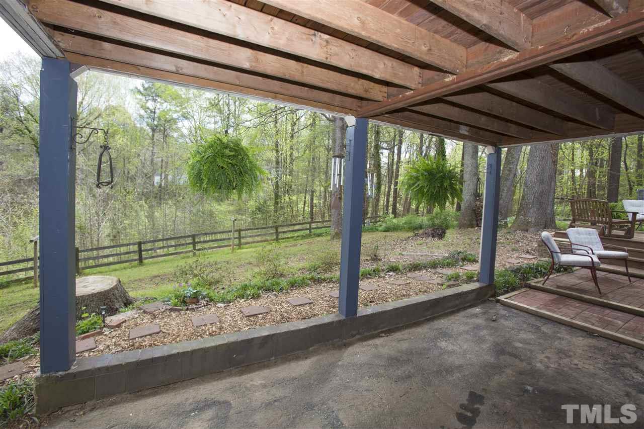 11100 Creedmoor Road Raleigh, NC 27614 - Photo 7 of 25 a view of a porch with chairs and backyard