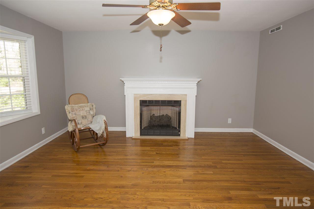 11100 Creedmoor Road Raleigh, NC 27614 - Photo 8 of 25 a living room with furniture and a fireplace