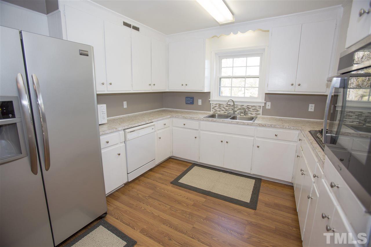 11100 Creedmoor Road Raleigh, NC 27614 - Photo 10 of 25 a kitchen with white cabinets and refrigerator