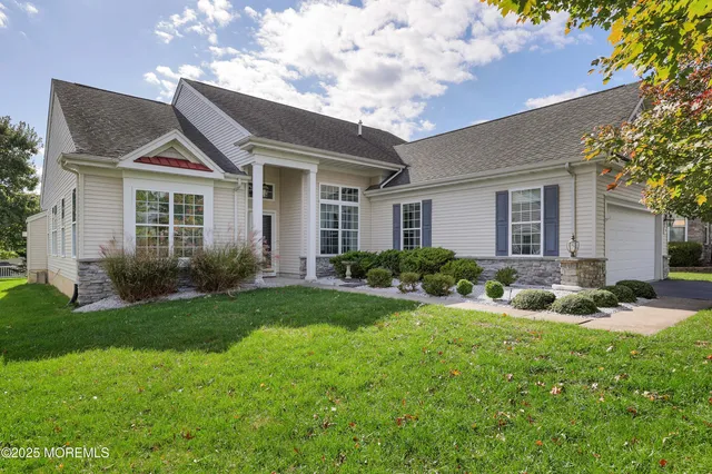 a front view of house with yard and green space