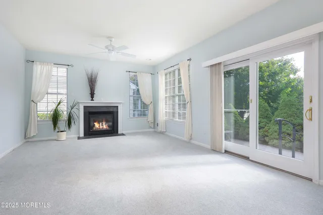 an empty room with furniture and a fireplace