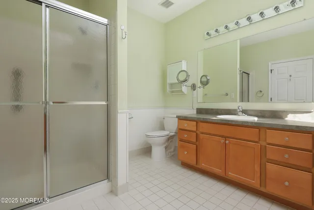 a spacious bathroom with a double vanity sink mirror and toilet