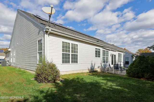 a house view with a sitting space and garden