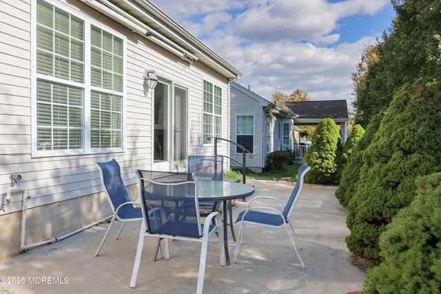 a view of a house with backyard and sitting area