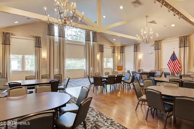 a living room with furniture and a book shelf