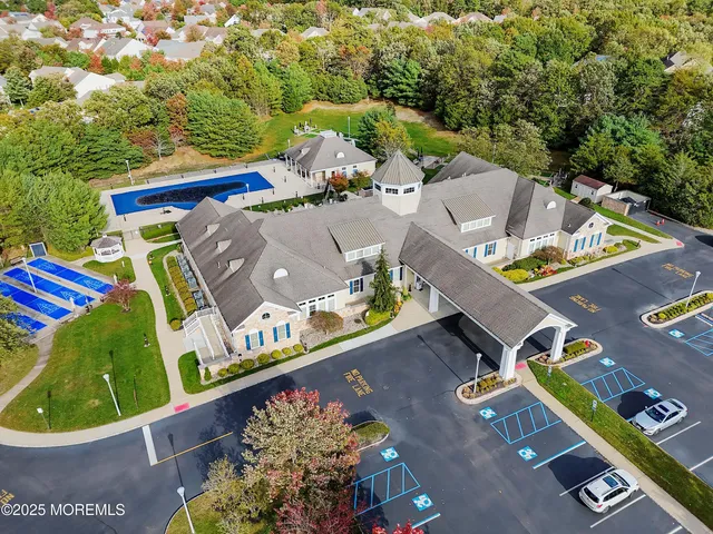 an aerial view of a house with garden space and lake view
