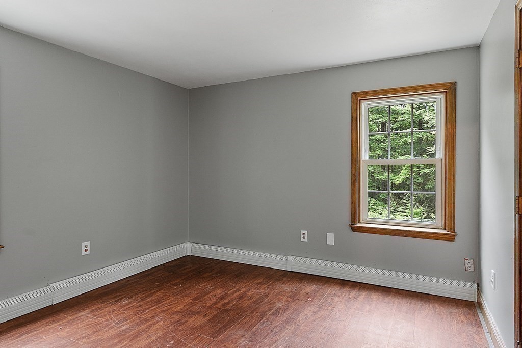 102 B Lunenburg Road Townsend, MA 01474 - Photo 20 of 41 a view of an empty room with wooden floor and a window