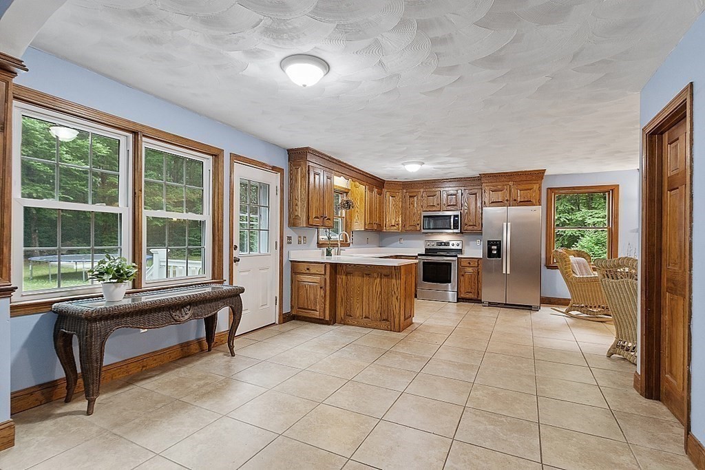 102 B Lunenburg Road Townsend, MA 01474 - Photo 10 of 41 a large kitchen with kitchen island granite countertop a large counter top and stainless steel appliances