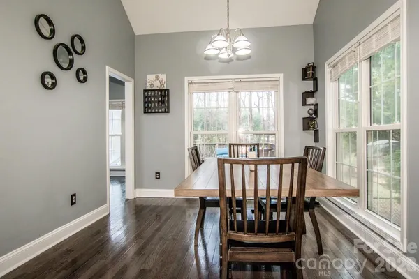 a view of a dining room with furniture wooden floor and chandelier