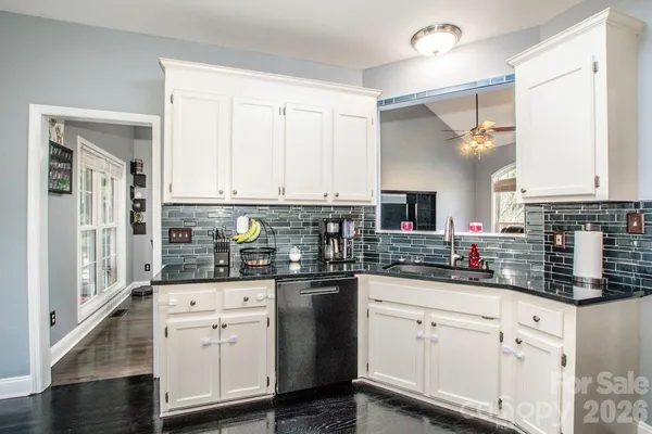a kitchen with stainless steel appliances a sink stove refrigerator and cabinets