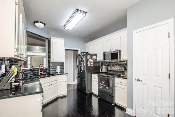 a kitchen with stainless steel appliances a stove a sink and a refrigerator