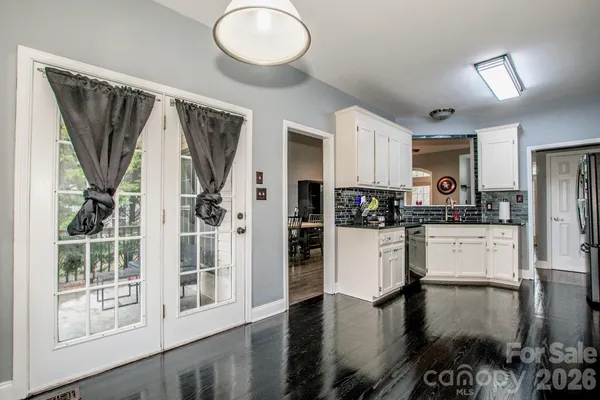 a bed sitting in a bedroom next to a window and a dresser