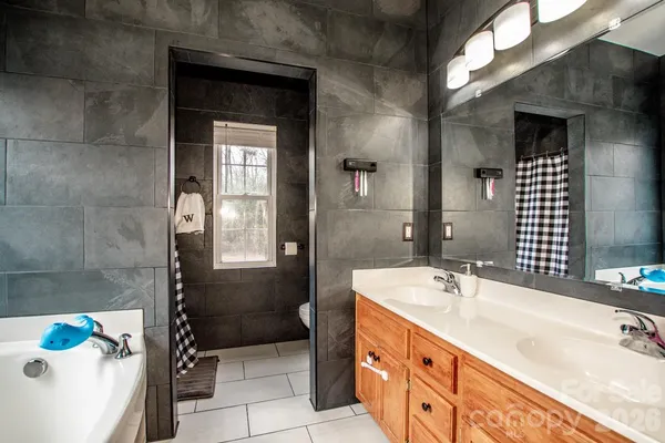 a bathroom with a sink a bathtub and a shower