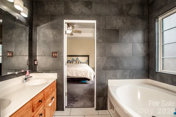 a view of walk in closet with clothes