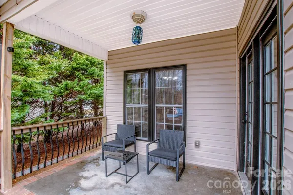 a balcony with furniture and a potted plant