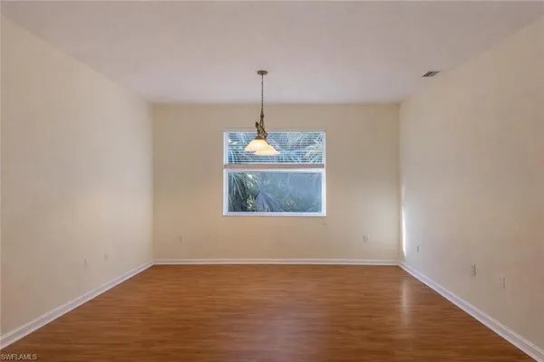 a room with a window and wooden floor
