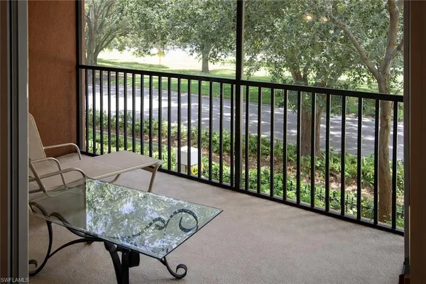 a view of a balcony with furniture