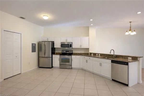 a kitchen with a sink and refrigerator