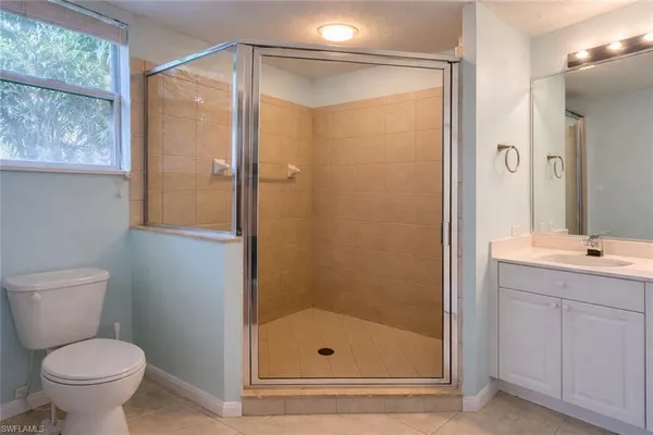 a bathroom with a shower a toilet and sink