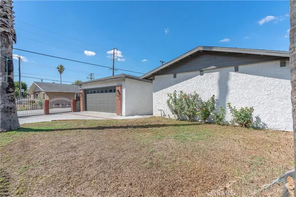 a view of a house with a yard and a garage