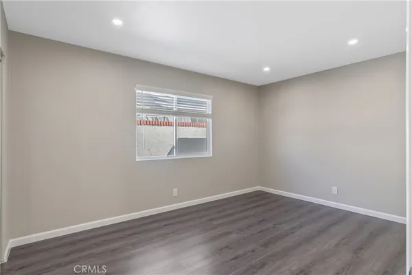 a room with wooden floor and natural light