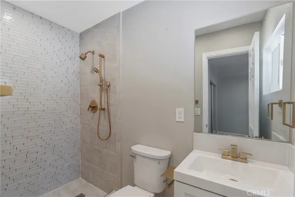 a bathroom with a toilet sink and shower