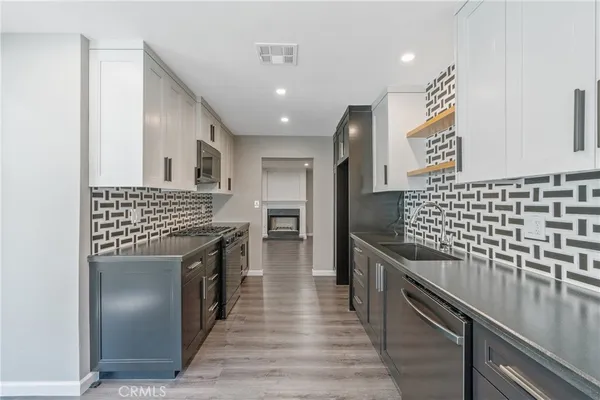 a kitchen with granite countertop stainless steel appliances and wooden cabinets