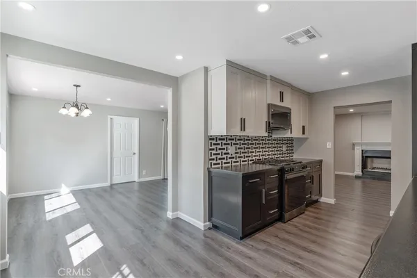 a kitchen with stainless steel appliances granite countertop a stove top oven and sink