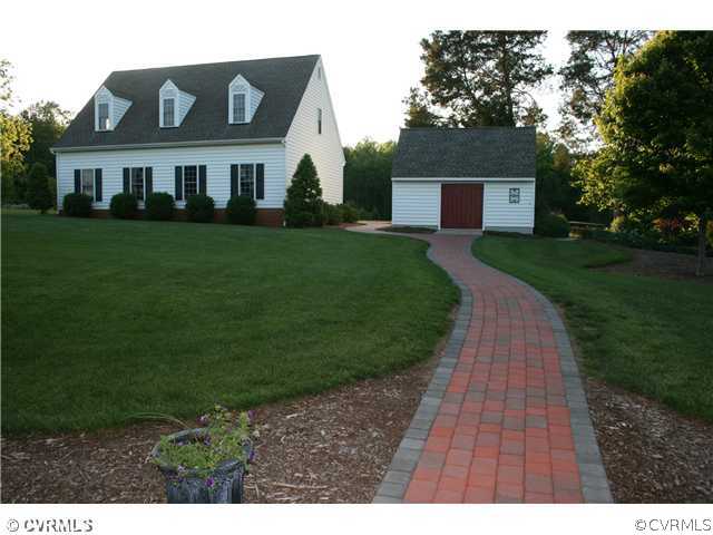 1826 Rabbit Warren Road Manakin-Sabot, VA 23103 - Photo 3 of 12 a front view of a house with a yard