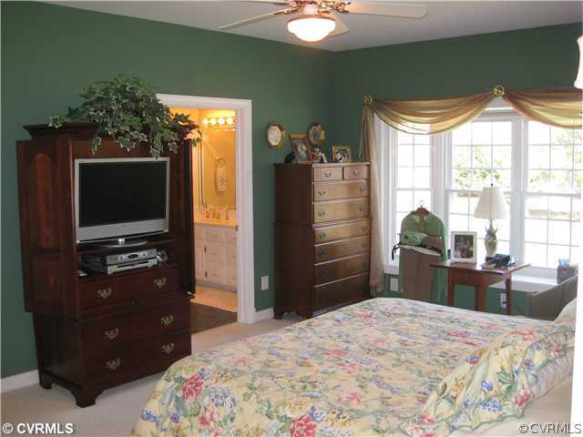 1826 Rabbit Warren Road Manakin-Sabot, VA 23103 - Photo 10 of 12 a bedroom with a bed and a flat tv screen on dresser