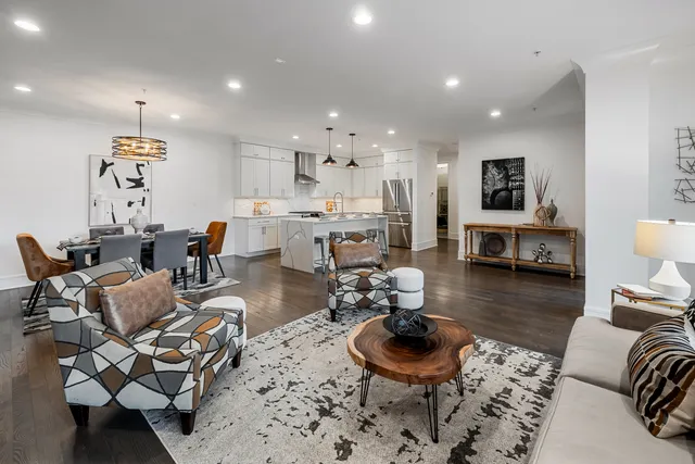 a view of a dining room with furniture wooden floor and a chandelier