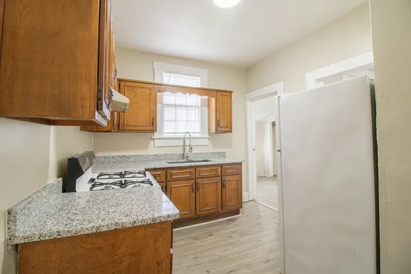 a kitchen with stainless steel appliances granite countertop a sink stove and refrigerator