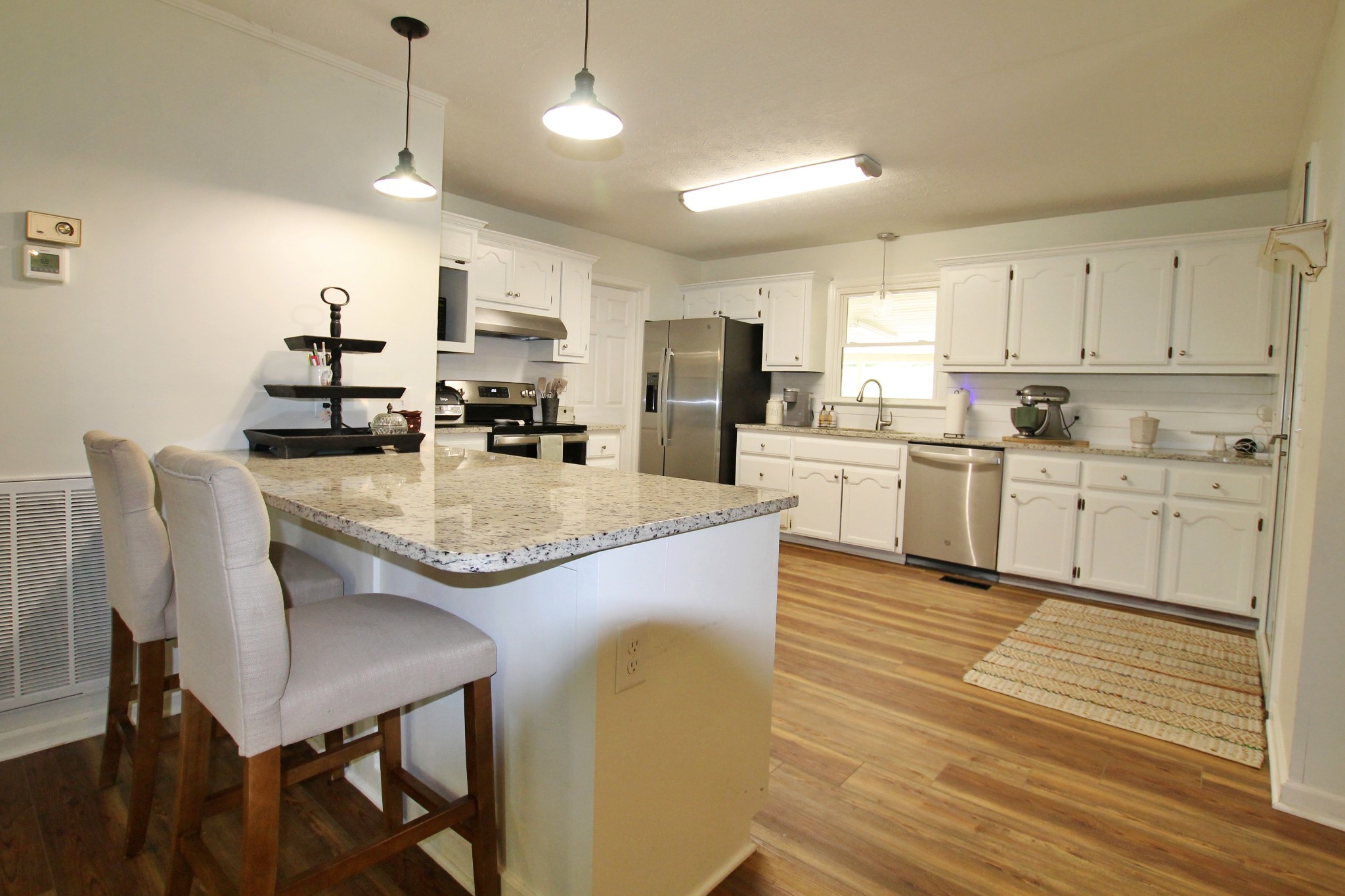 101 Timberlake Drive Springfield, TN 37172 - Photo 10 of 38 a kitchen with kitchen island granite countertop a sink a counter space stainless steel appliances cabinets and a center island