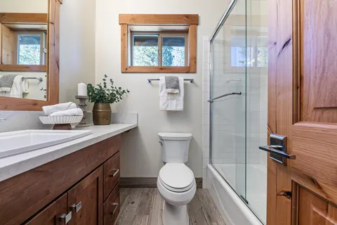 a bathroom with a toilet a sink and mirror