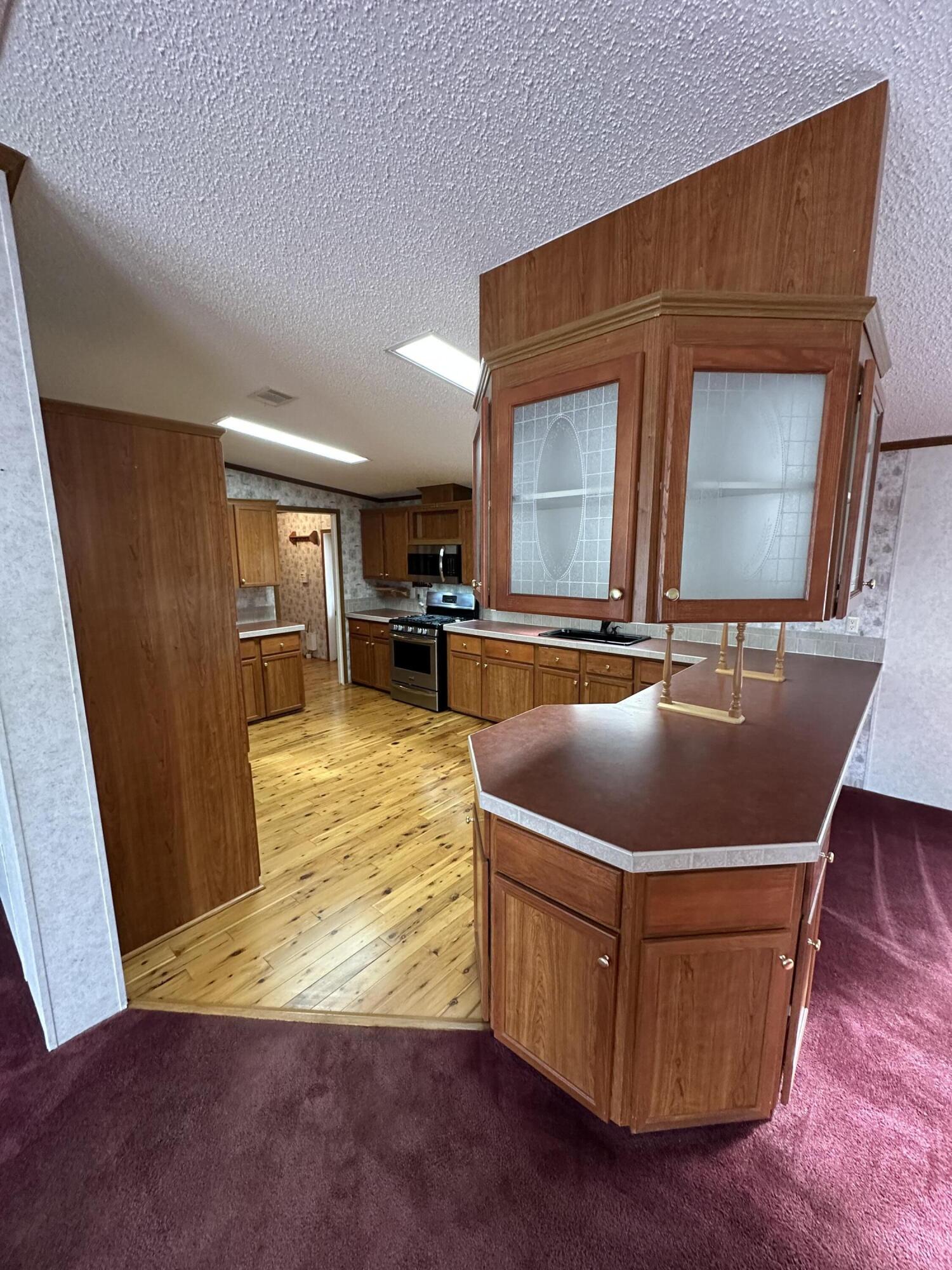 618 Oakridge Road DeFuniak Springs, FL 32433 - Photo 14 of 46 a living room with wooden floor and a table