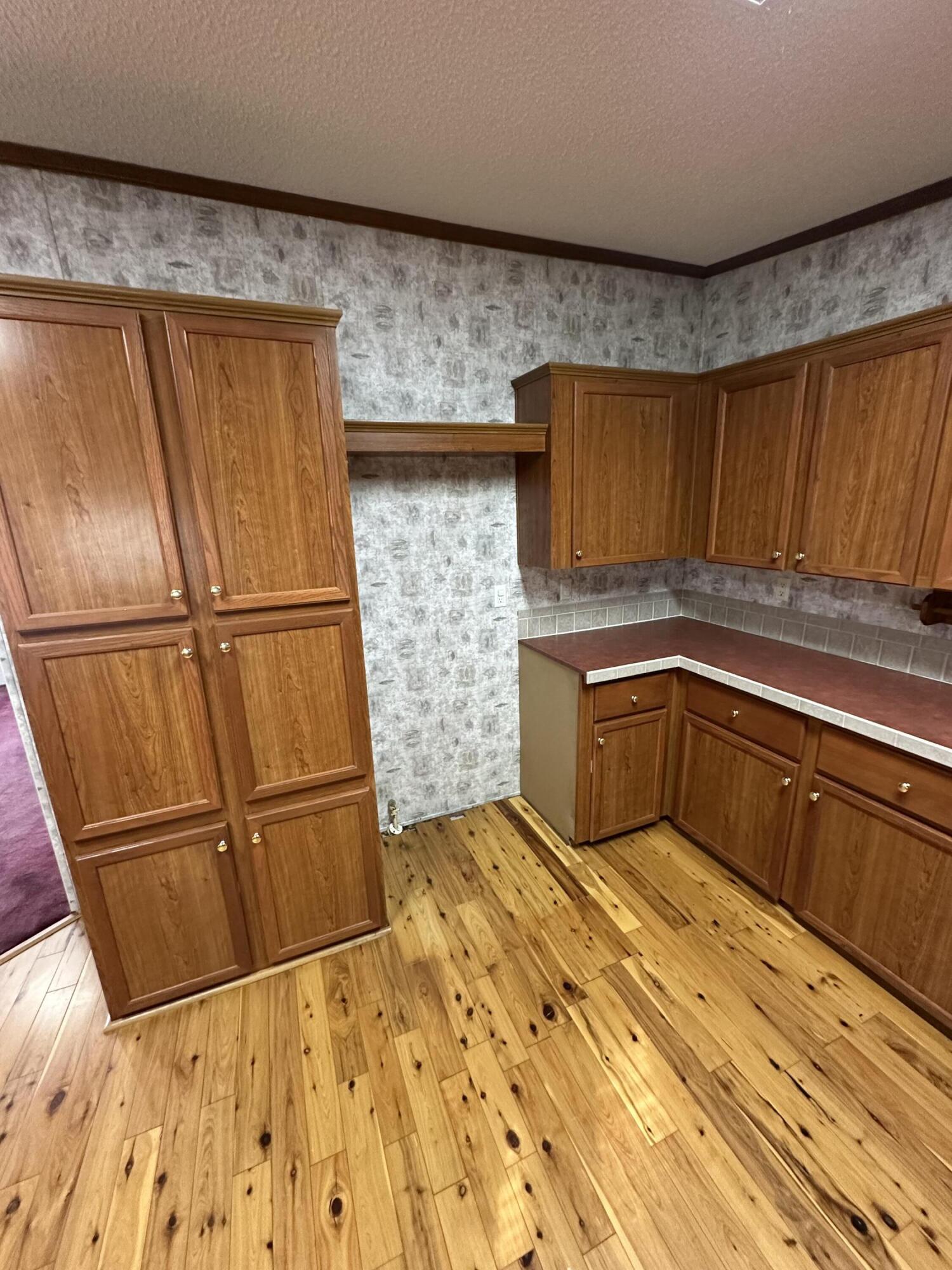 618 Oakridge Road DeFuniak Springs, FL 32433 - Photo 15 of 46 a kitchen with wooden cabinets and a sink