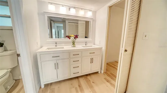 a bathroom with a tub a sink and mirror