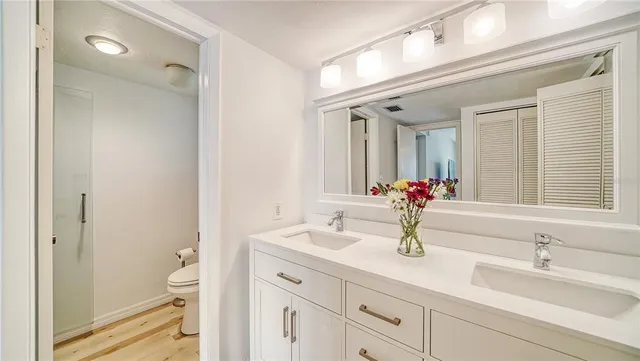 a bathroom with a shower and a glass door